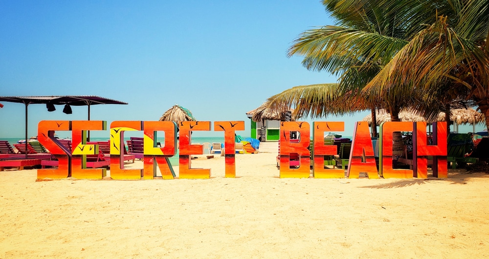 The secret Beach sign - one of the best things to do in Belize with Kids while staying at the best family resort in Belize